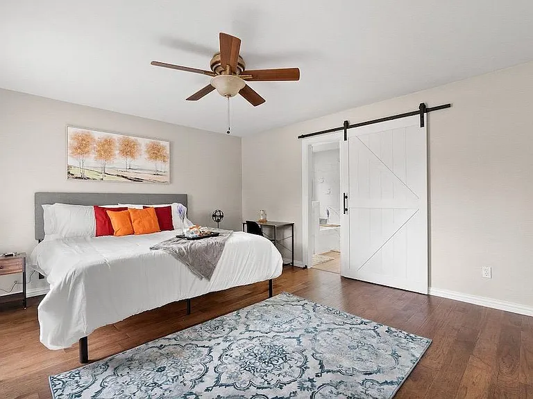 Master bedroom with King bed and a premium mattress and linens. Includes night stands, lamps with USB ports, windows have dark out ultimate closure blinds, has a walk in spacious closet. Elegant barndoor leads you to a luxurious en-suite.