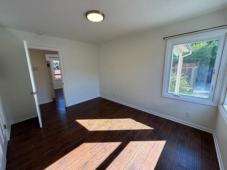 Bedroom #1 with multiple corner windows and spacious double door closet.