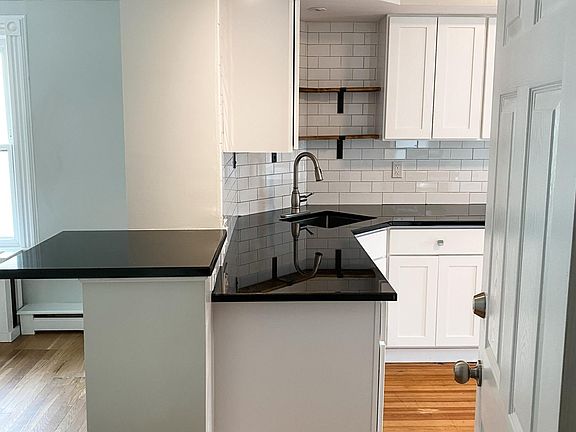 A small bar-height counter joins the kitchen and living room and allows your guests to enjoy your company while dinner cooks.