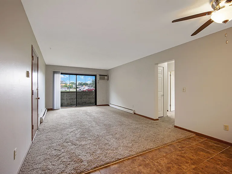 Spacious living room/dining room with ceiling fan