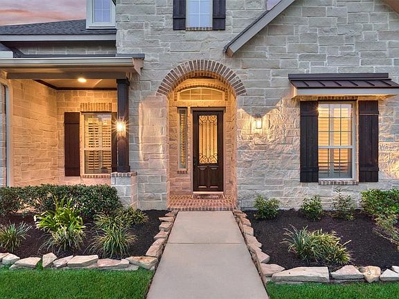 Imagine relaxing on this front covered patio to catch the even breeze.