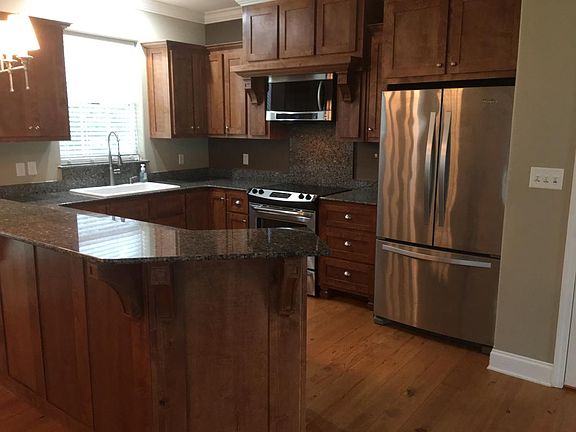 open kitchen with granite and stainless appliances