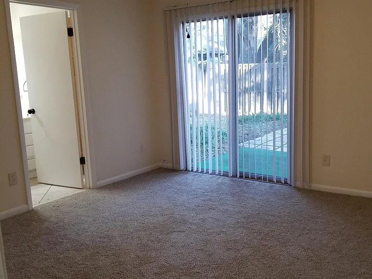 Master bedroom with deck in enclosed backyard