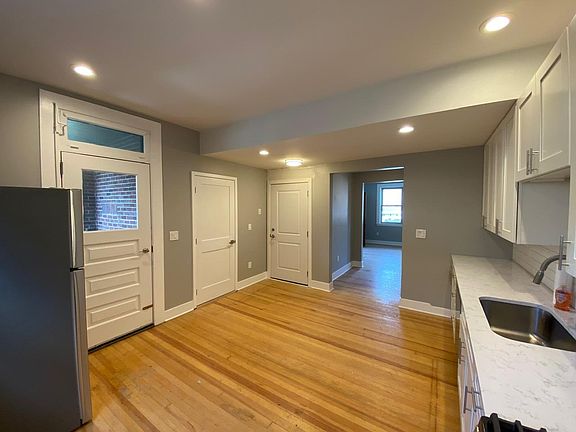 View from kitchen to back terrace and corridor through to main living room.