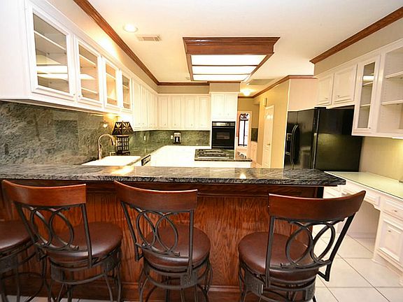 Breakfast bar opening to the kitchen.