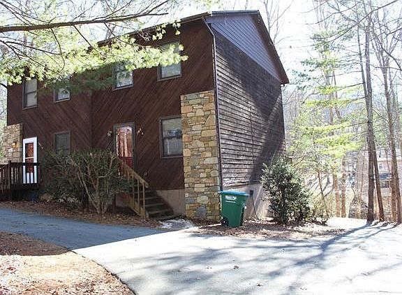 Driveway either curves around for easy egress or goes down below for extra parking and garage access