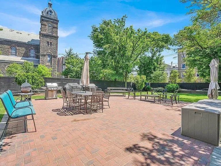 Beautiful green space with sitting area and BBQ grills for residents' use, located within the gates of the community.