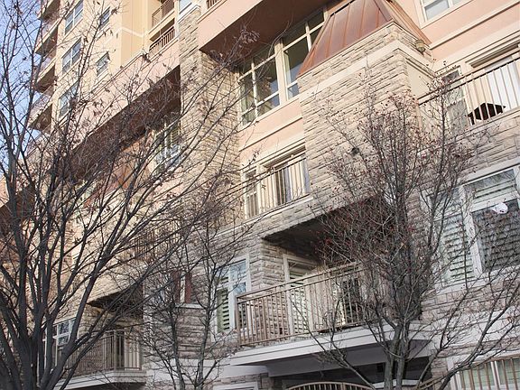 Exterior of townhome with gated main level and upstairs patio space