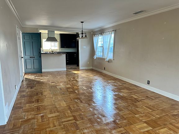 The living room looking towards the front of the home and the kitchen