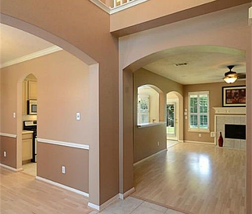 The front door opens to this fabulous two-story Foyer with designer tile
