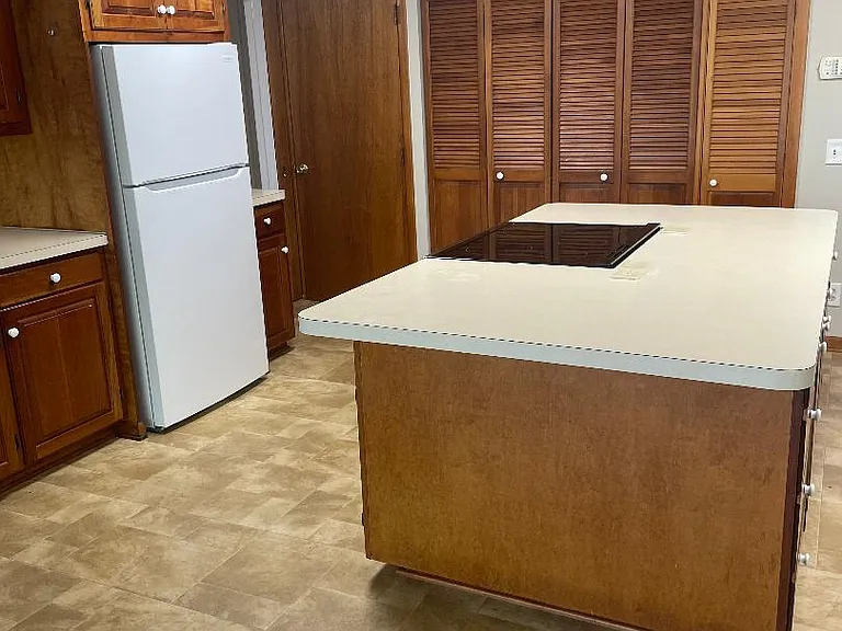 Laundry area behind louvered doors plus pantry behind solid door.