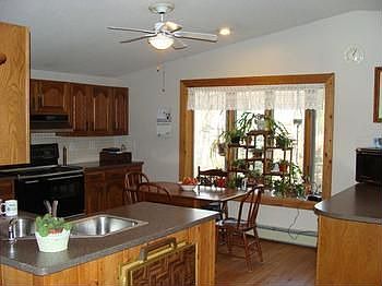 New oak kitchen with corian countertops and eating area in the kitchen