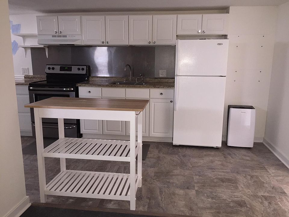 Kitchen with full size stove and refrigerator.