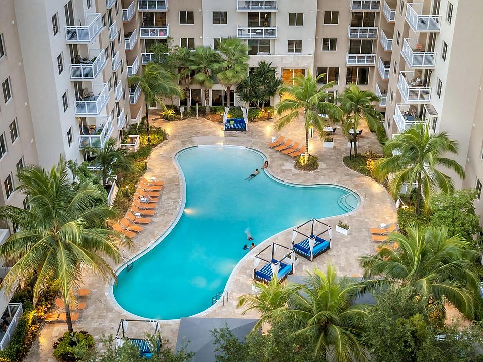 Expansive Pool with Lounge Chairs and Lush Landscaping