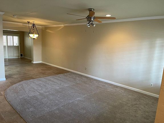 Guests entering the home from the front door are welcomed by the cheery living room.