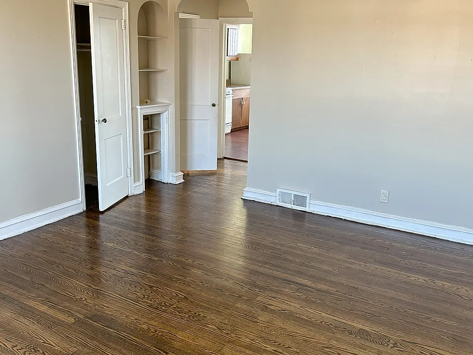 Living room with closet view looking into kitchen