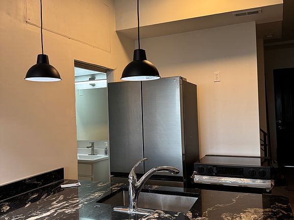 Kitchen with a view of downtown Cincinnati, with a door leading to a 1/2 bathroom.