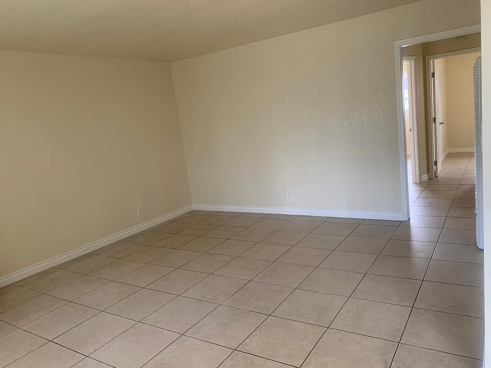 Large living room with a lot of natural light.