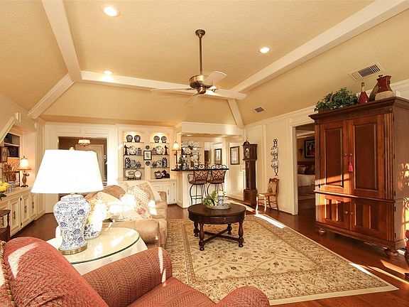 Another view of the Living Room facing the wet bar and 2 built in shelving and cabinets for extra storage.