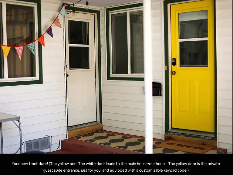 The yellow door is the separate entrance for the one-bedroom tenant. The white door enters the main house next to the washer-dryer.