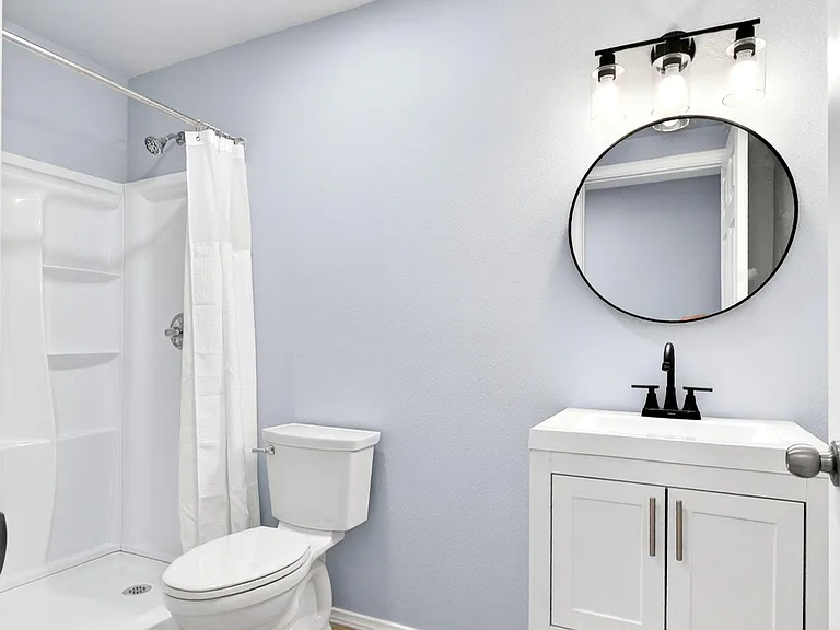 Updated full bath with tub/shower combo, sleek vanity storage, and modern fixtures for easy daily routines.