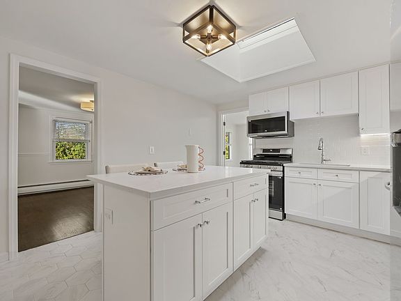 Enjoy the sunlit breakfast bar dining in this modern, and upgraded kitchen with new skylights