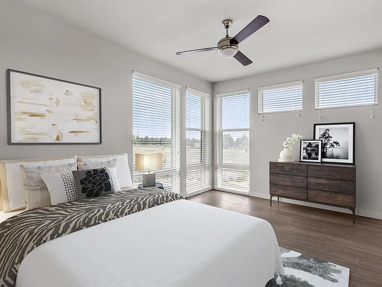 Spacious Bedroom with Natural Light and Ceiling Fan
