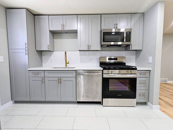 Kitchen includes granite countertops, gas range, brand new cabinets with brass pulls and more!