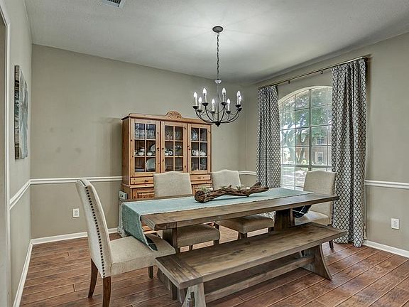 This formal dining room has a chair rail and easily accommodates a large table and a china cabinet.