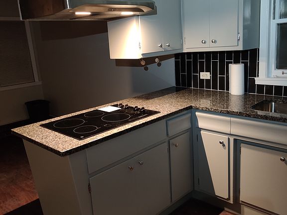 New granite counters, cooktop, range hood, tile backsplash