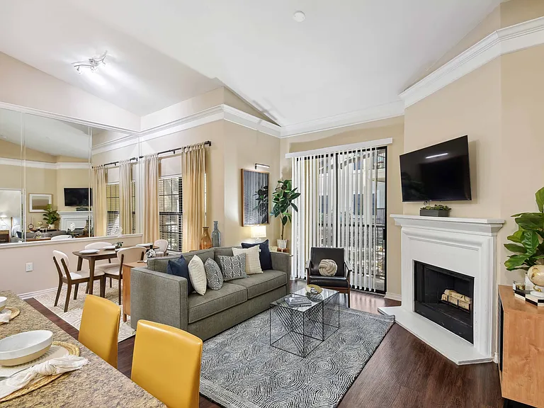 Living room with oversized windows for plentiful natural light and direct access to a private patio or balcony.