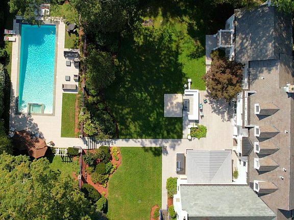 Aerial view of the thoughtfully designed pool area and expansive stone patios.