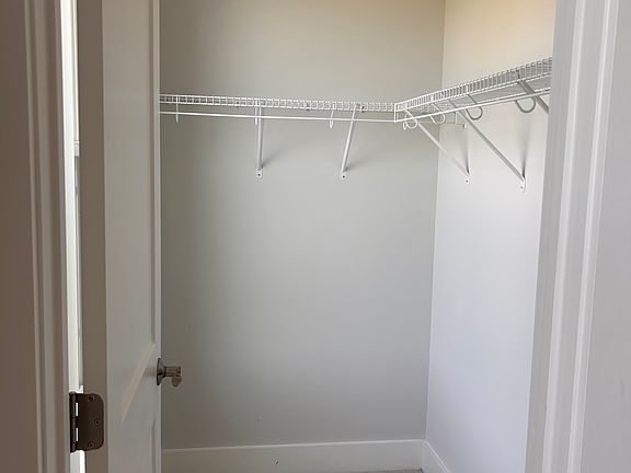 Smaller walk-in closet in the primary bedroom.