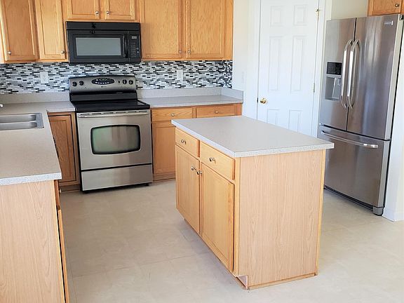 Kitchen features walk in pantry, stainless appliances, and island. New tile flooring to be installed prior to occupancy