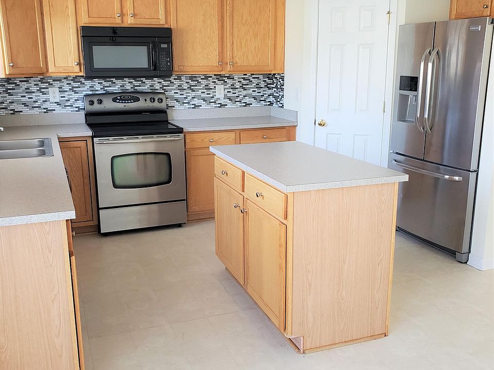Kitchen features walk in pantry, stainless appliances, and island. New tile flooring to be installed prior to occupancy