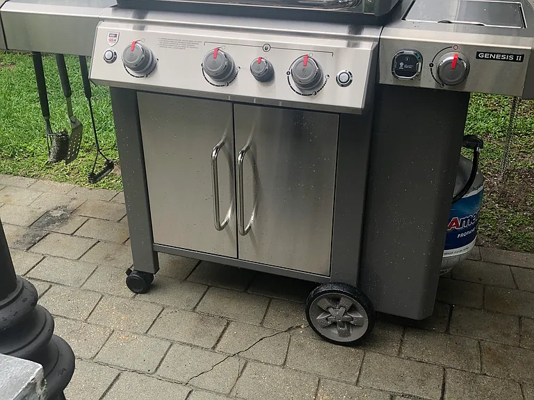 common webber gas grill in courtyard