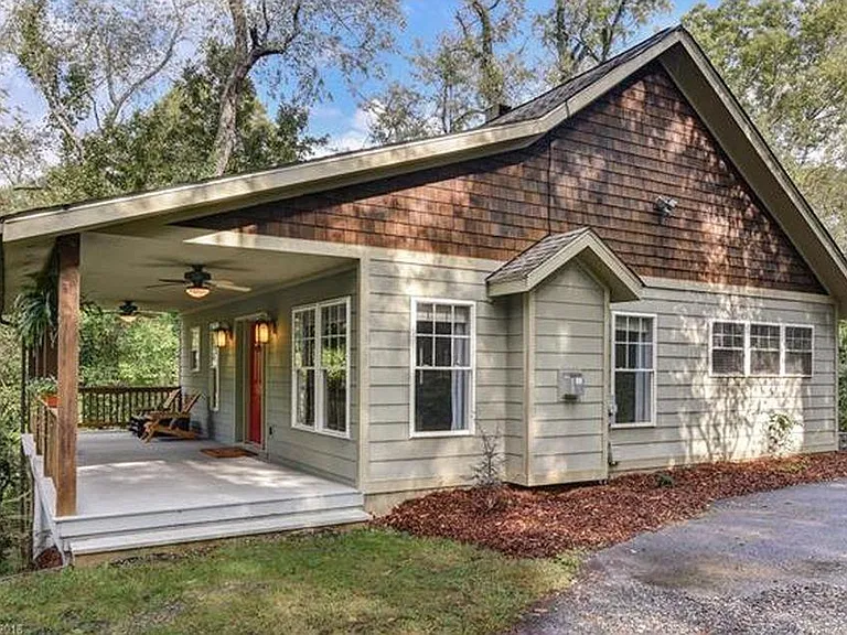 Spacious 300 sq ft front porch with ceiling fans and cafe lights.