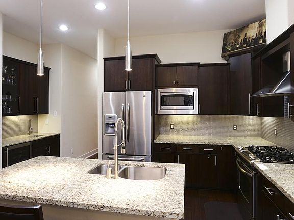 Gleaming kitchen with beautiful granite, stainless appliances, and modern finishes. Built in wine fr