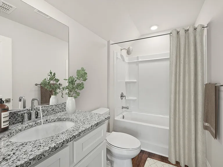 Secondary suite bathroom with a tub and shower combination