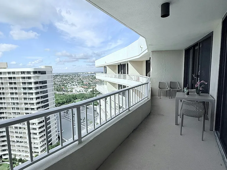 Spacious extended balcony featuring seating, tables, and loungers