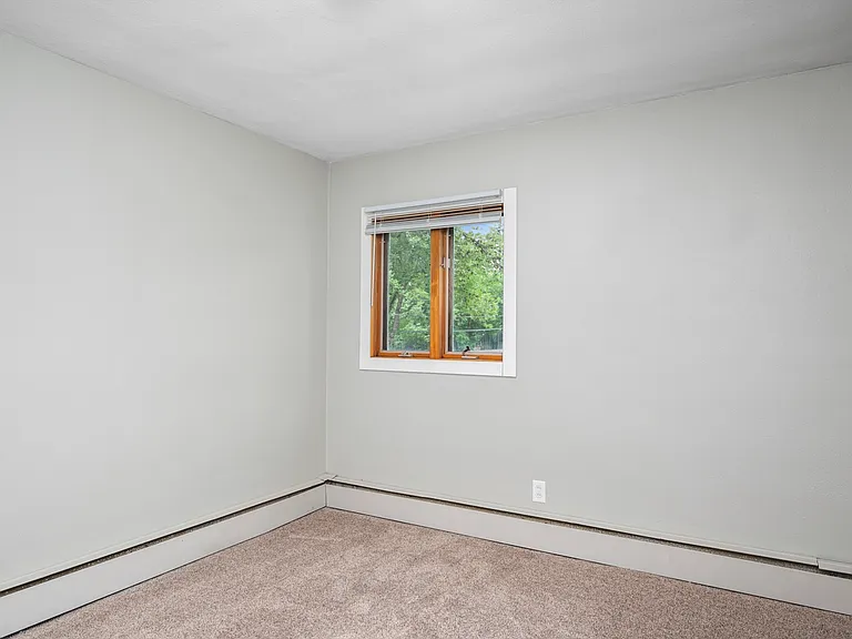 Bright room with a cozy window view and fresh cream-colored walls, perfect for a personal retreat. Bright room with a cozy window view and fresh cream-colored walls, perfect for a personal retreat.