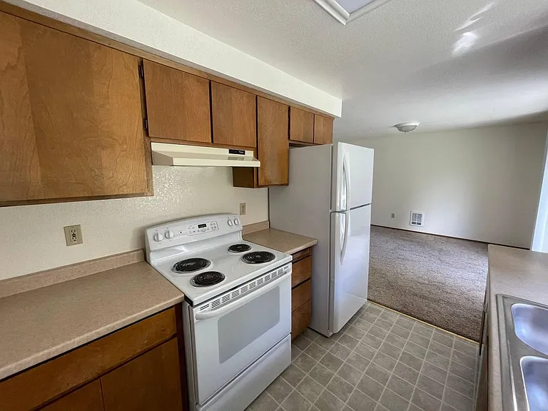 Bright kitchen with ample cabinet space and included appliances