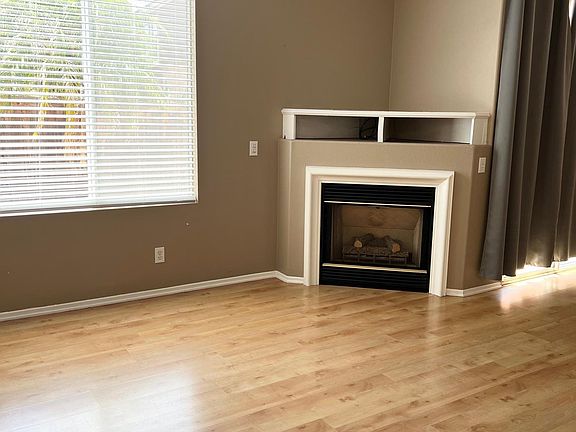 Step inside to laminate floors throughout, fireplace and modern paint