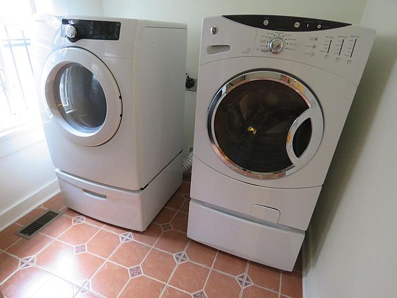 Full size washer and dryer in laundry room.
