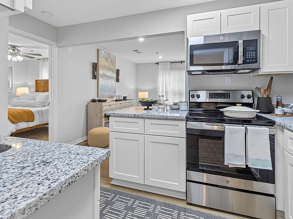 Stylish Kitchen with White Cabinets and Grey Granite Counters