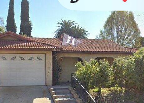 Front of home has privacy due to rosebushes