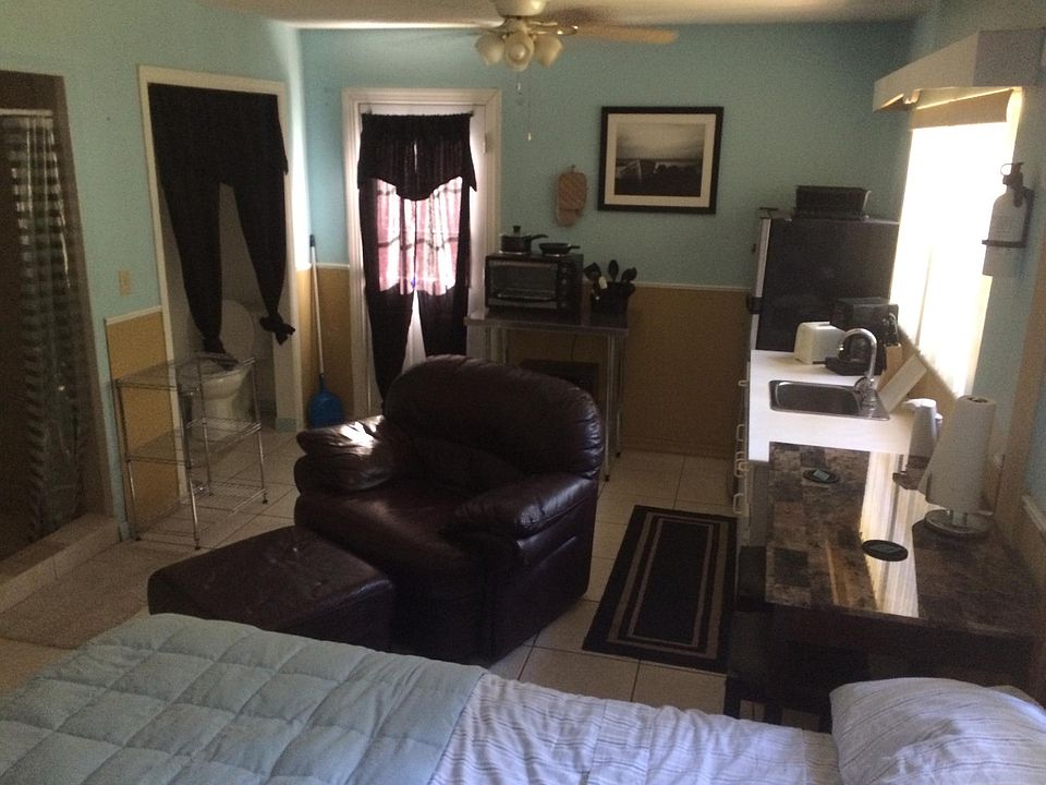 leather chair with ottoman, kitchenet, bathroom and shower