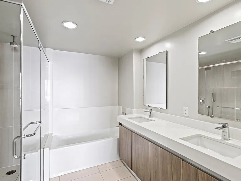 Master Bathroom with Double-Sink Vanity, Full-Size Bathtub, and a Walk-In Shower