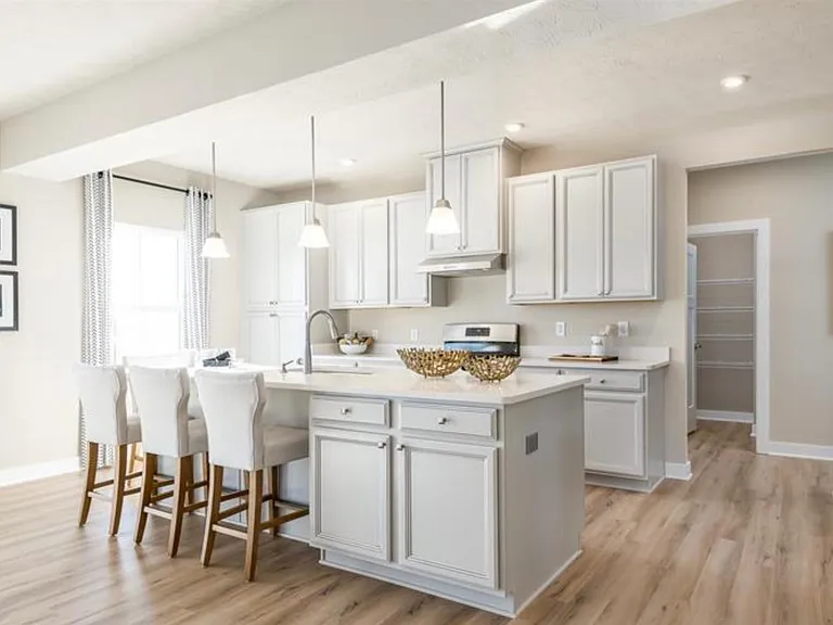 Open Kitchen with White Cabinets and Granite Counter Top Stainless Steel Appliances with Builder Upgrades including large Pantry