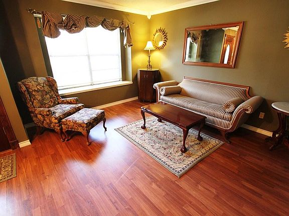 Formal living with wood laminate floors.